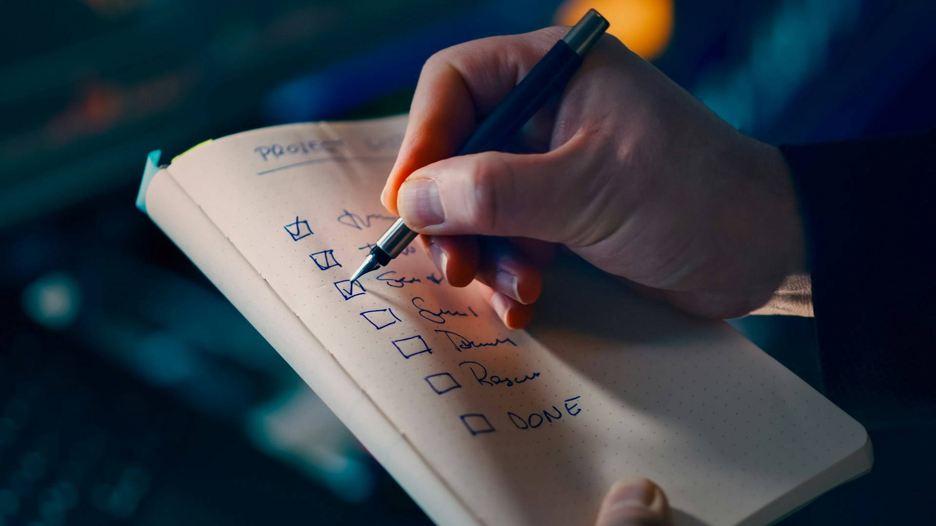 Hand checking off items on a to-do list.